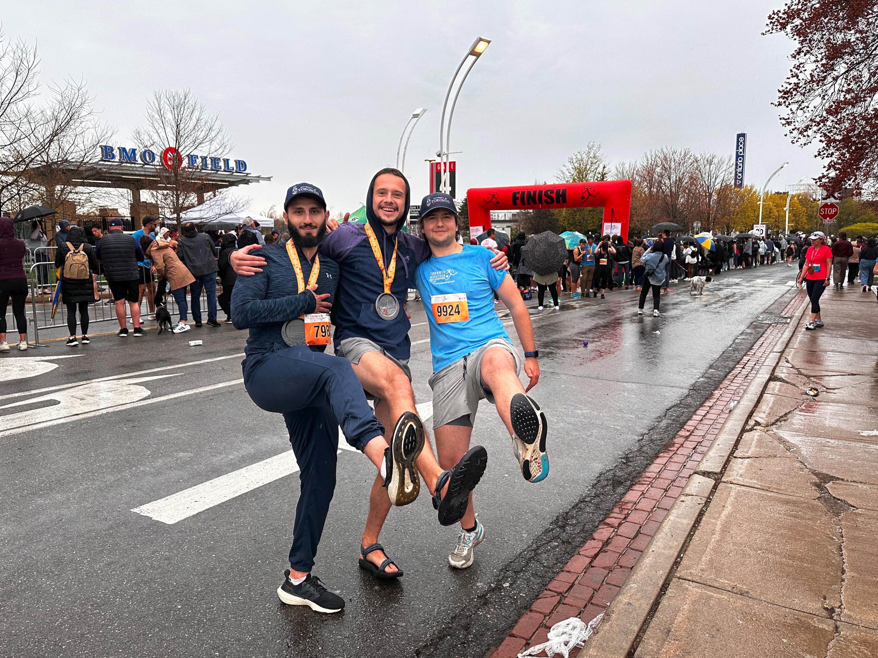 A picture of me with three friends holding our soles up after finishing half marathons